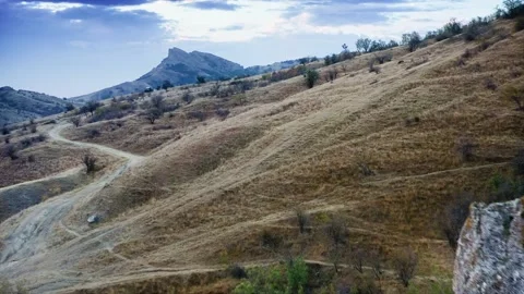 Flying over sun-sun-burnt grass on hill in autumn. Drone aerial shot. Stock Footage 218403610