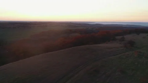 Flying over the sunset forest belt in autumn Video stock 152986248