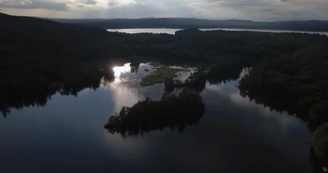 Flying over sunset reflection in beautiful New England lake Stock Footage 111525074