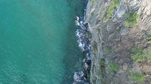 Flying over the surface of the blue water and the shore of lake Baikal Stock Footage 121925698