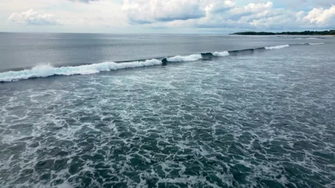 Flying over the surface of the dark blue sea with waves toward the horizon. Stock Footage 238875759
