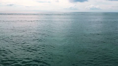 Flying over the surface of the dark turquoise sea toward the horizon. Stock Footage 238875411