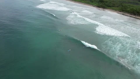 Flying Over Surfers And Triangular Breakers With Aerial Pan Stock Footage 212495428