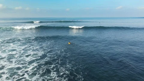 Flying Over Surfers Going to the Waves Stock Footage 119512622