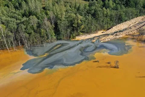 Flying over surreal patterns of flowing colorful mining chemical residuals .. 스톡 사진