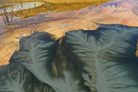 Flying over surreal patterns of flowing colorful mining chemical residuals .. 스톡 사진