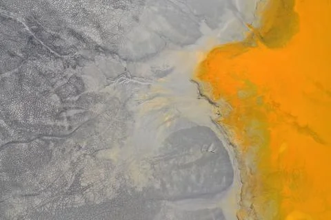 Flying over surreal patterns of flowing colorful mining chemical residuals .. 스톡 사진