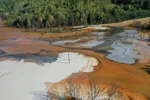 Flying over surreal patterns of flowing colorful mining chemical residuals .. Stock Photos