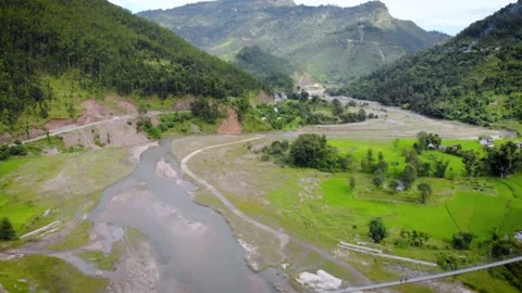 Flying over suspension bridge on the mountain tiver, aerial video Stock Footage 156010860