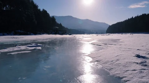 Flying over the thawing mountain river in spring Video stock 104023862