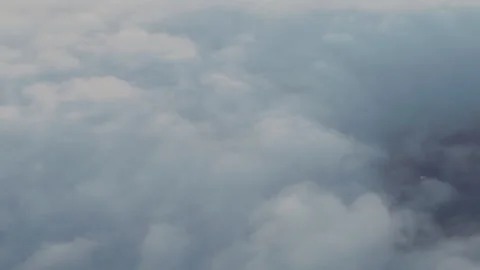 Flying over thick clouds with glimpses of farmland below Stock-Footage 347983204