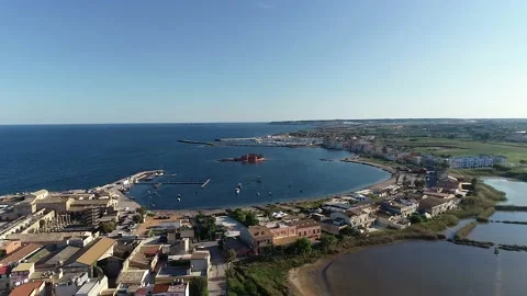 Flying over the tile roofs that surround the marina in Marzamemi, Sicily Stock Footage 179367893
