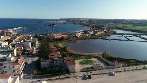 Flying over the tile roofs that surround the marina in Marzamemi, Sicily Stock Footage 179367902