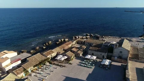 Flying over the tile roofs that surround the marina in Marzamemi, Sicily Stock Footage 179368015