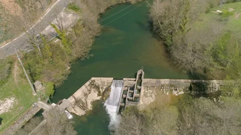 Flying over tiny water dam with fishway in beautiful landscape around Stock Footage 152652492