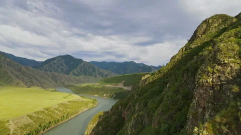 Flying over the top of the mountain in summer in cloudy weather Stock Footage 245135203