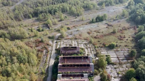 Flying over the top of three abandoned coal mine buildings 動画素材 162910565