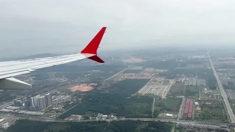 Flying over town city through window of aircraft plane on the wing  Stock Footage 230060733