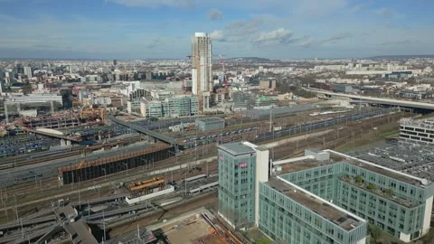 Flying over train station toward Tour Pleyel Tower with Paris cityscape in Stock Footage 247167345
