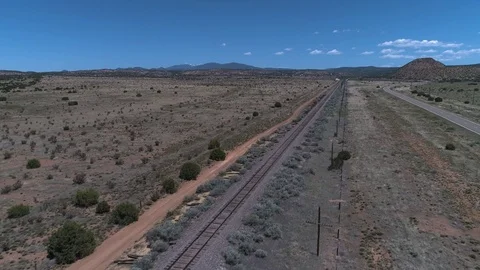 Flying over train tracks in the desert Stock Footage 79237156