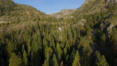 Flying over trees to and past a waterfall in fast motion. Stock Footage 90564164