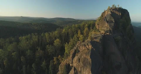 Flying over the trees in the forest overlooking the high cliff Stock Footage 166894231