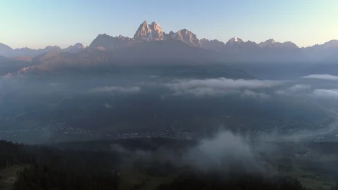 Flying over the trees in mountain valley in summer evening in evening Stock Footage 99611092