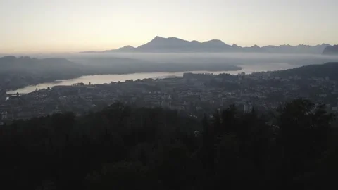 Flying over trees toward mountain dusk Stock Footage 161452790