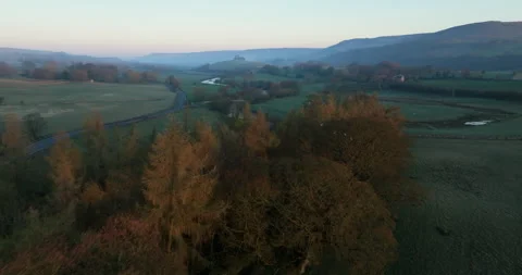 Flying over treetops and still river in Yorkshire Dales Stock Footage 307428558