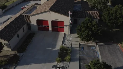 Flying over a US Fire Station with a US Flag Flying. Stock Footage 108760875