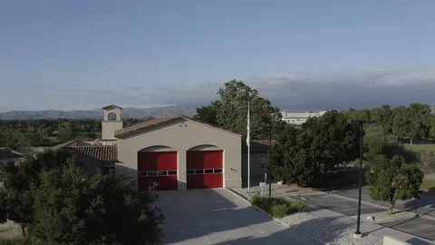 Flying over a US Fire Station in Orange County California with a US Flag Flying. Stock Footage 108773641
