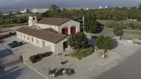 Flying over a US Fire Station in Orange County California with a US Flag Flying. Stock Footage 108778292