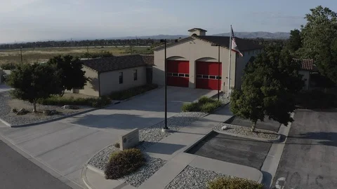 Flying over a US Fire Station in Orange County California with a US Flag Flying. Stock Footage 108780252