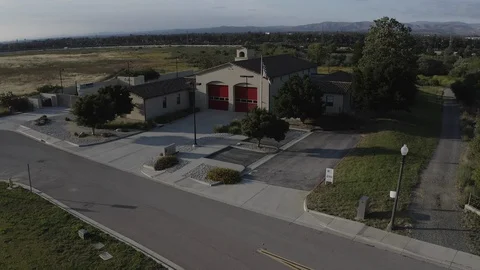 Flying over a US Fire Station in Orange County California with a US Flag Flying. Stock Footage 108805753