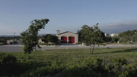 Flying over a US Fire Station with a US Flag Flying. Stock Footage 109406637