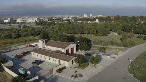 Flying over a US Fire Station in Orange County California with a US Flag Flying. Stock Footage 109429745