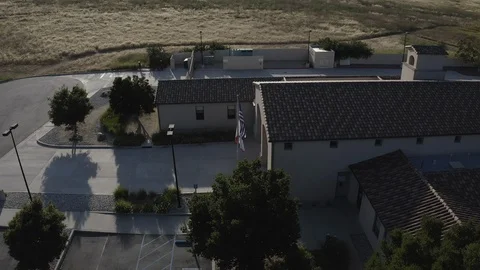 Flying over a US Fire Station in Orange County California with a US Flag Flying. Stock Footage 109433992