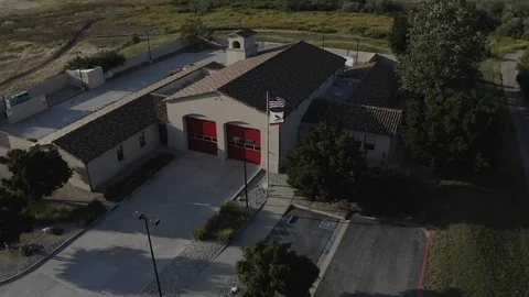Flying over a US Fire Station in Orange County California with a US Flag Flying. Stock Footage 109434166