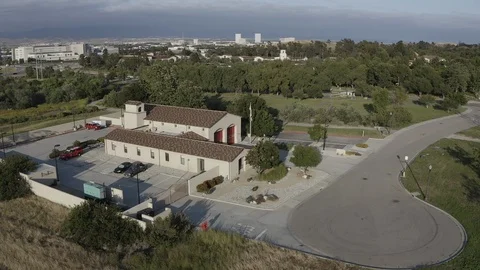 Flying over a US Fire Station in Orange County California with a US Flag Flying. Stock Footage 109442273