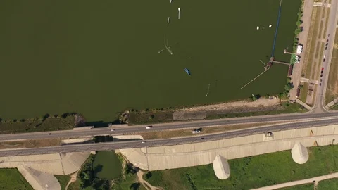 Flying over wakeboarding cable wake park aerial video. Water extreme sport. Stock Footage 118717378