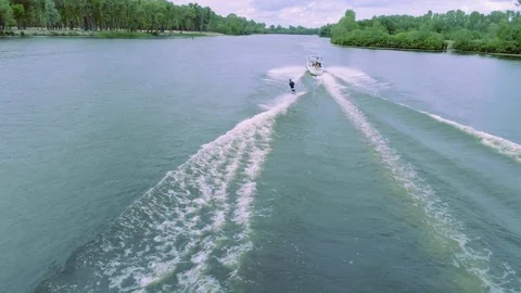 Flying over wakeboarding river 4k aerial video. Wakeboarder tricks: flip jump Stock Footage 79241209