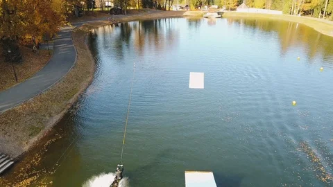 Flying over wakeboarding on river 4k aerial video. Stock Footage 98983088
