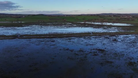 Flying over Walmore Common flooded nature reserve in early morning. Stock Footage 263746182