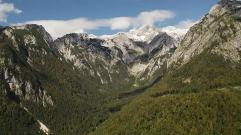 Flying Over Warm Lit Forest Valley in The Spring With Clouds Making Shadows Видео 168498032