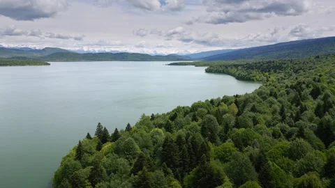 Flying over water and forest, fog over a mountain lake, aerial view Stock Footage 276874408