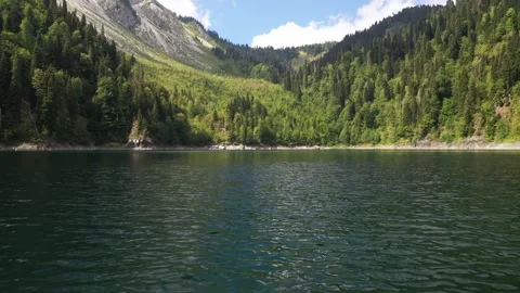 Flying over water and tree tops, Smaller Ritsa Lake, Abkhazia Stock Footage 152512699