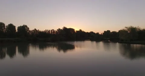 Flying over water at sunrise Stock Footage 62228861