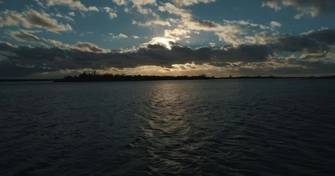 Flying Over Water Into Sunset Stock-Footage 96179214