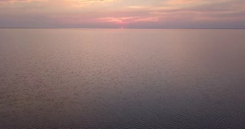 Flying over the water at sunset Stock Footage 112913622