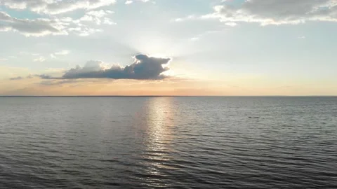 Flying over the water at sunset Stock Footage 136784216